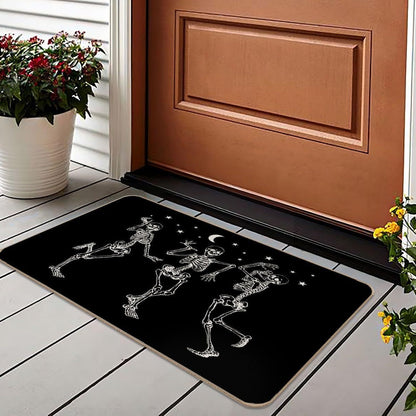 A black rectangular doormat with a white skeleton dancing pattern, placed in front of a brown door on a white tiled porch with potted plants.