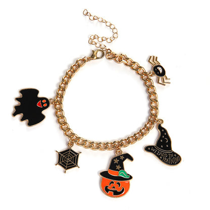 A gold-tone chain charm bracelet featuring Halloween-themed charms including a black ghost with red eyes, a spider, a spiderweb, a jack-o'-lantern, a witch hat with the phrase 'I'M NOT IN HEAVEN', and a small spider on a chain extension, shown on a white background.