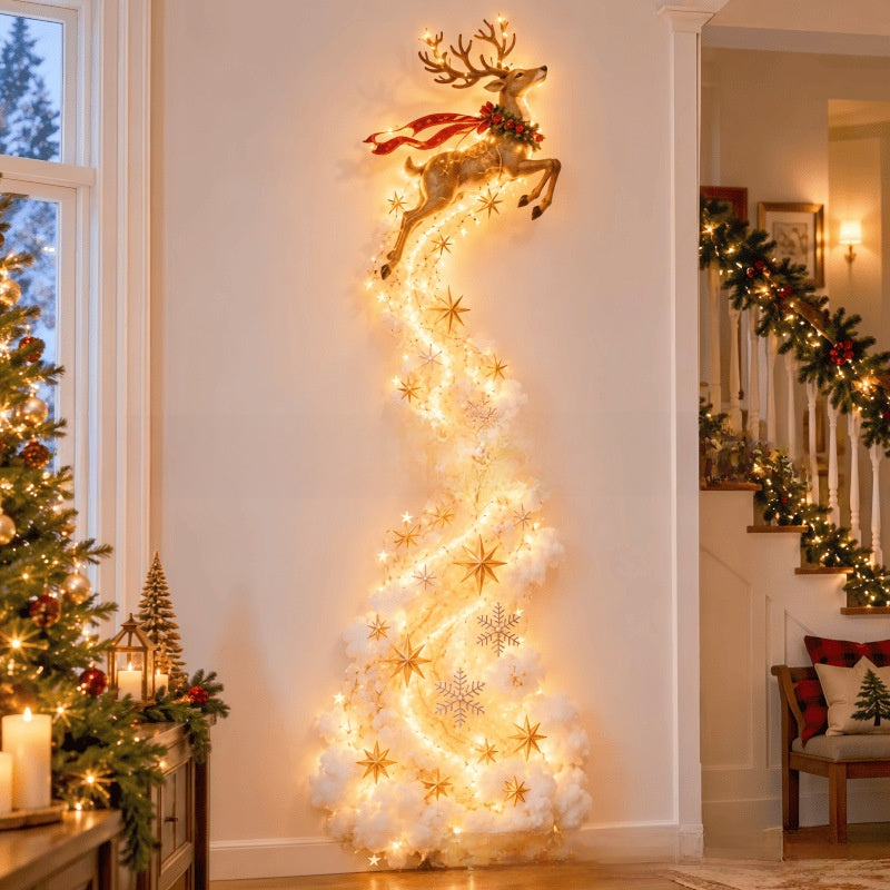 A tall, whimsical Christmas tree decoration shaped like a golden reindeer leaping down a glowing spiral of warm white fairy lights and white fluffy branches, decorated with gold stars and snowflakes, set in a decorated holiday home interior.