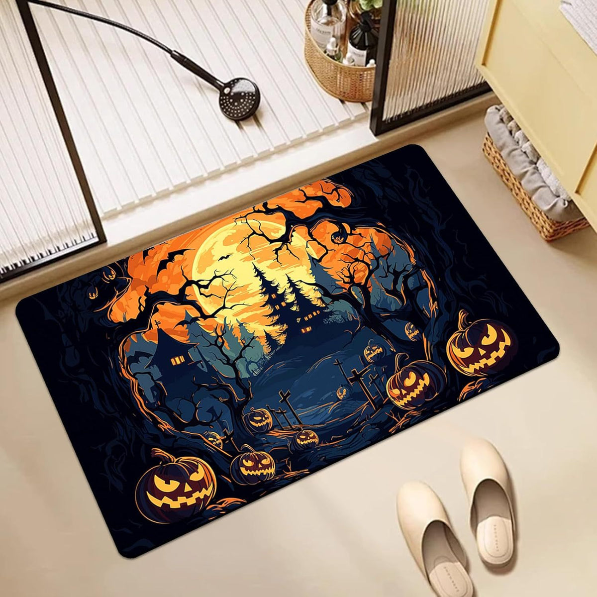 A rectangular Halloween-themed floor mat with a spooky forest scene, jack-o'-lanterns, and a full moon, shown on a light beige floor in a styled room setting with slippers and decor.