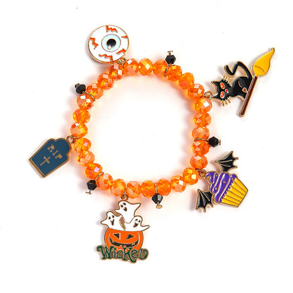 An orange beaded charm bracelet featuring Halloween-themed enamel charms including a tombstone, eyeball, witch cat on a broom, cupcake, and a pumpkin with the word 'Wicked' below it, shown on a white background.
