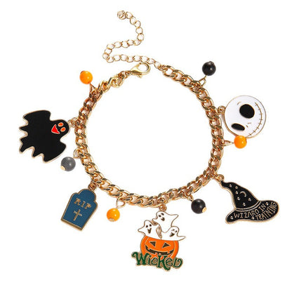 A gold-tone charm bracelet featuring Halloween-themed charms including a black bat, a tombstone reading 'R.I.