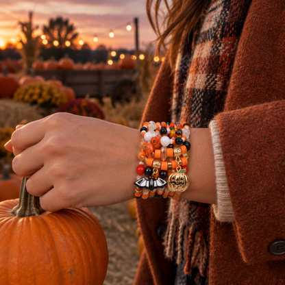 Adult at a pumpkin patch wearing a beaded Halloween bracelet