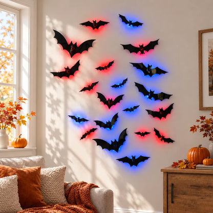 Black bat wall decals with red and blue LED light accents arranged in a flight pattern on a beige wall in a cozy, autumn-themed living room.
